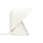 White Clérachic table lamp on a white backdrop, its smooth shade folded over a cone base, with a white cord at the left.