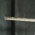 Close view of the end of this Clérachic chandelier, showing the ribbed clear glass segments joined along a lit tube.