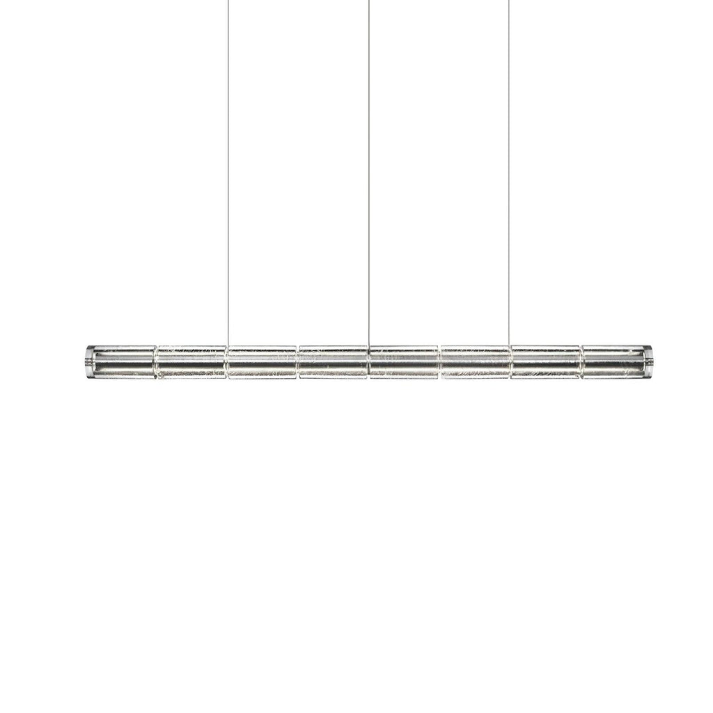 Slightly longer segmented glass linear chandelier from Clérachic with chrome end caps, hung on three cables on white.