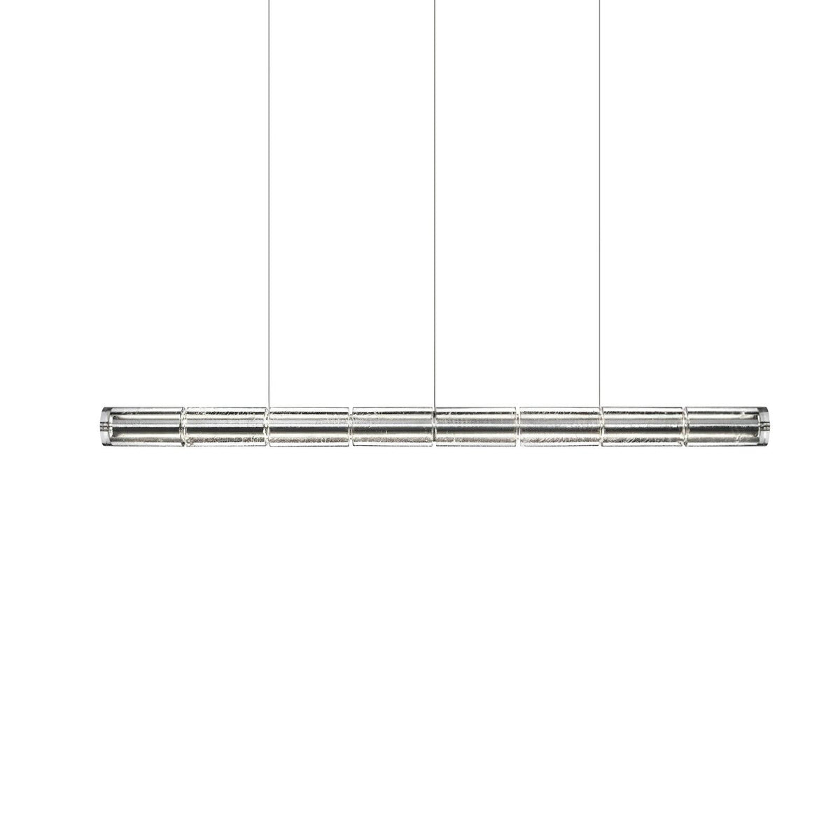 Slightly longer segmented glass linear chandelier from Clérachic with chrome end caps, hung on three cables on white.