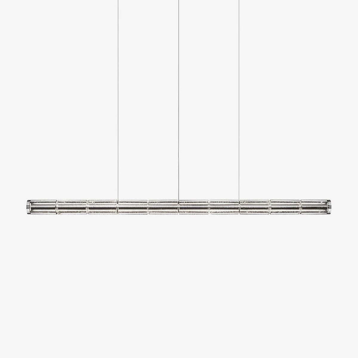 Long segmented glass chandelier from Clérachic with a chrome frame, hung on three cables against a pale grey backdrop.