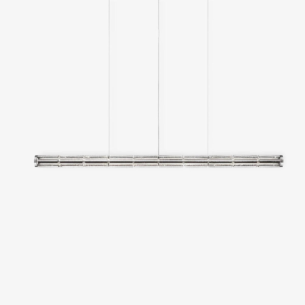 Unlit clear glass linear chandelier from Clérachic with chrome end caps, shown straight-on against a light grey studio backdrop.