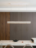Lit Clérachic glass chandelier below a white ceiling canopy, in front of a walnut-panelled wall with a marble counter beneath.