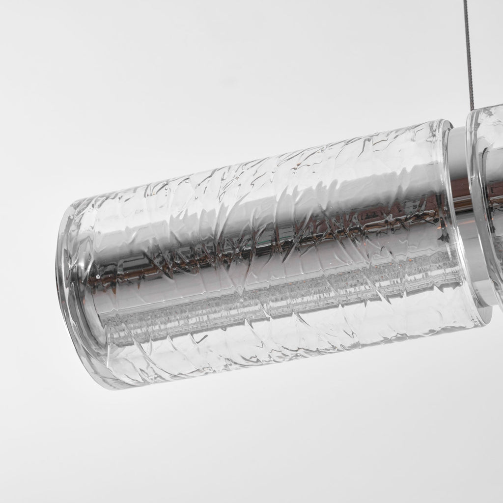 Close view of a clear crackle-textured glass segment on this Clérachic chandelier, with a chrome collar at the joint and a single cable above.