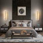A pair of Clérachic Selvia wall lights flanking a bed beneath a framed artwork.