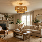 Above a stone fireplace and beige sofa, this Clérachic ceiling light glows through its two-tier hemp rope drum in gold hardware.