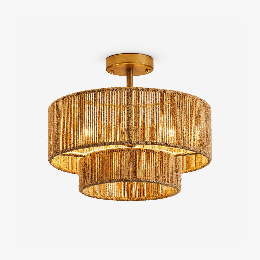 Product view of this Clérachic light's open hemp rope weave in gold hardware, its bulbs glowing through the rope tiers.