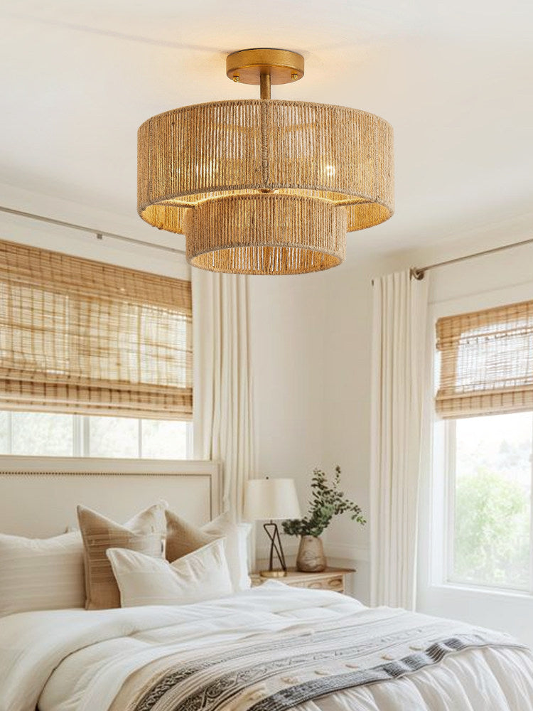 Beneath woven roman shades in a bright bedroom, this Clérachic ceiling light glows warm on its gold hardware.