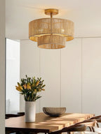 In a sunlit dining nook with a vase of flowers, this Clérachic light glows through its rope tiers in gold hardware.