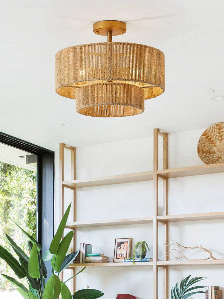 Above a bookshelf and glass doors opening to greenery, this Clérachic ceiling light glows warm in gold hardware.