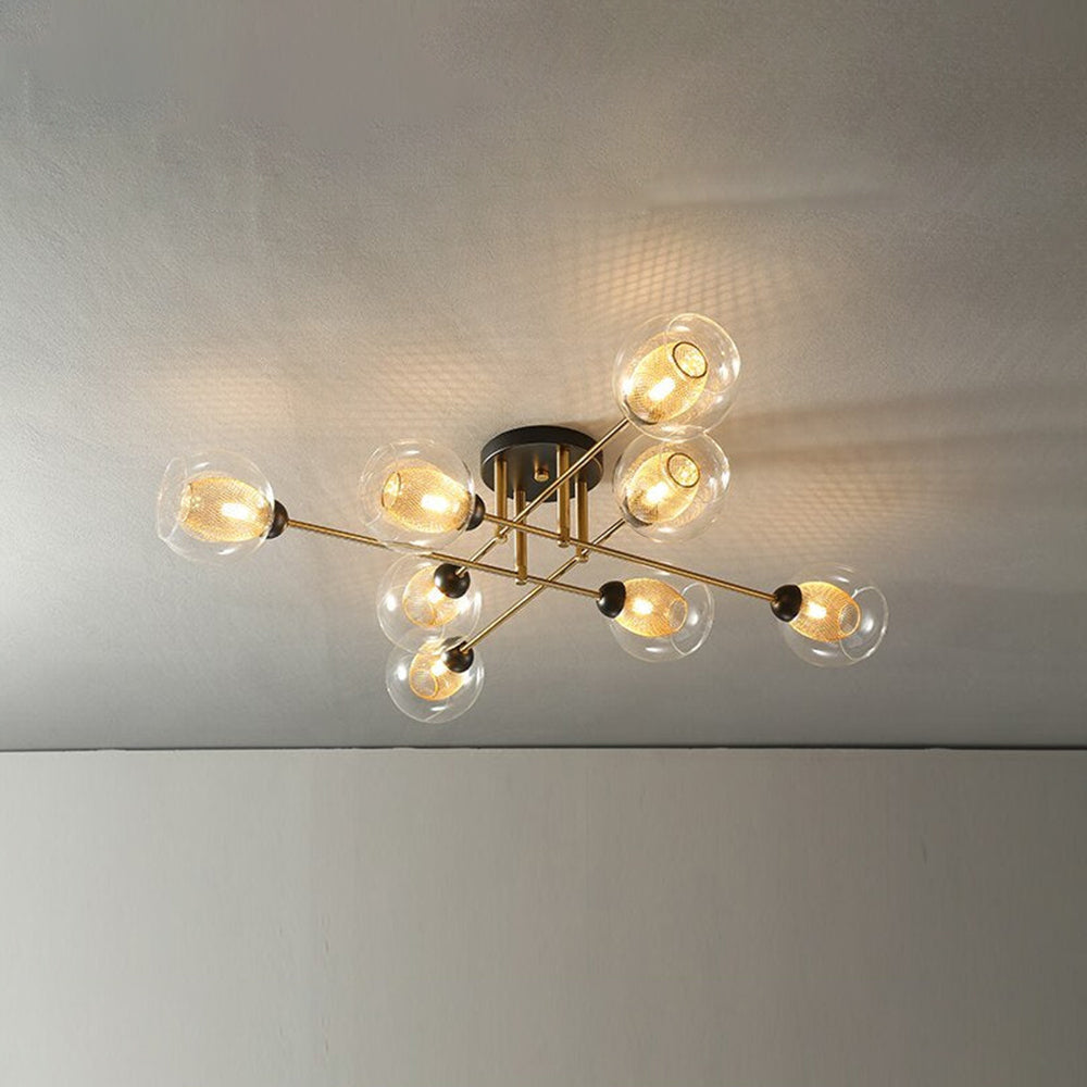 Eight transparent globes light up on this Clérachic sputnik chandelier, its brushed-gold rods crossing over a black canopy.