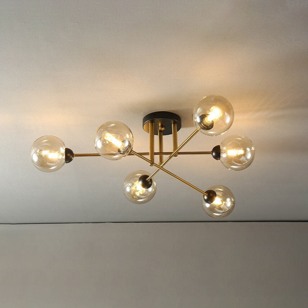Clérachic semi-flush chandelier in cognac glass, six amber globes glowing on gold rods just below a plain ceiling.