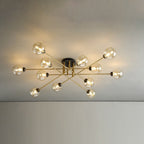 Twelve cognac globes span the ceiling on the Clérachic sputnik chandelier, honey-toned glass over slim brushed-gold rods.