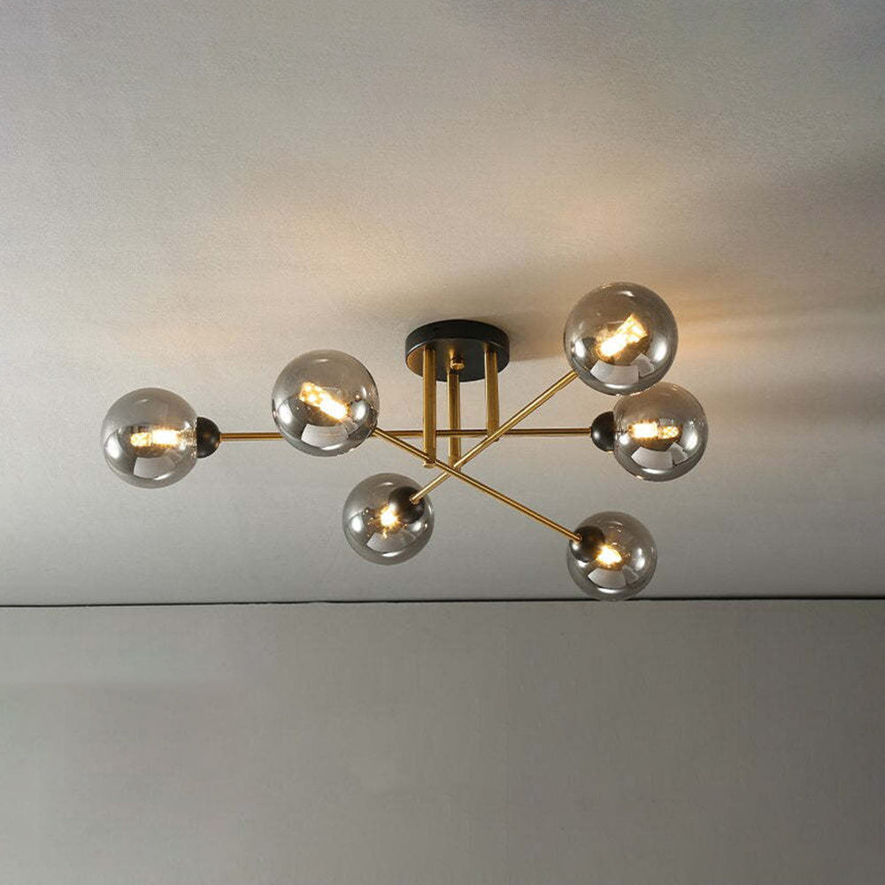 Clérachic sputnik chandelier fitted with six grey smoked globes, mirror-dark even lit, above a softly shadowed wall.