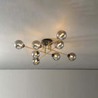 Eight grey smoked globes stay dark and reflective on this Clérachic semi-flush chandelier, gold rods crossing beneath the ceiling.