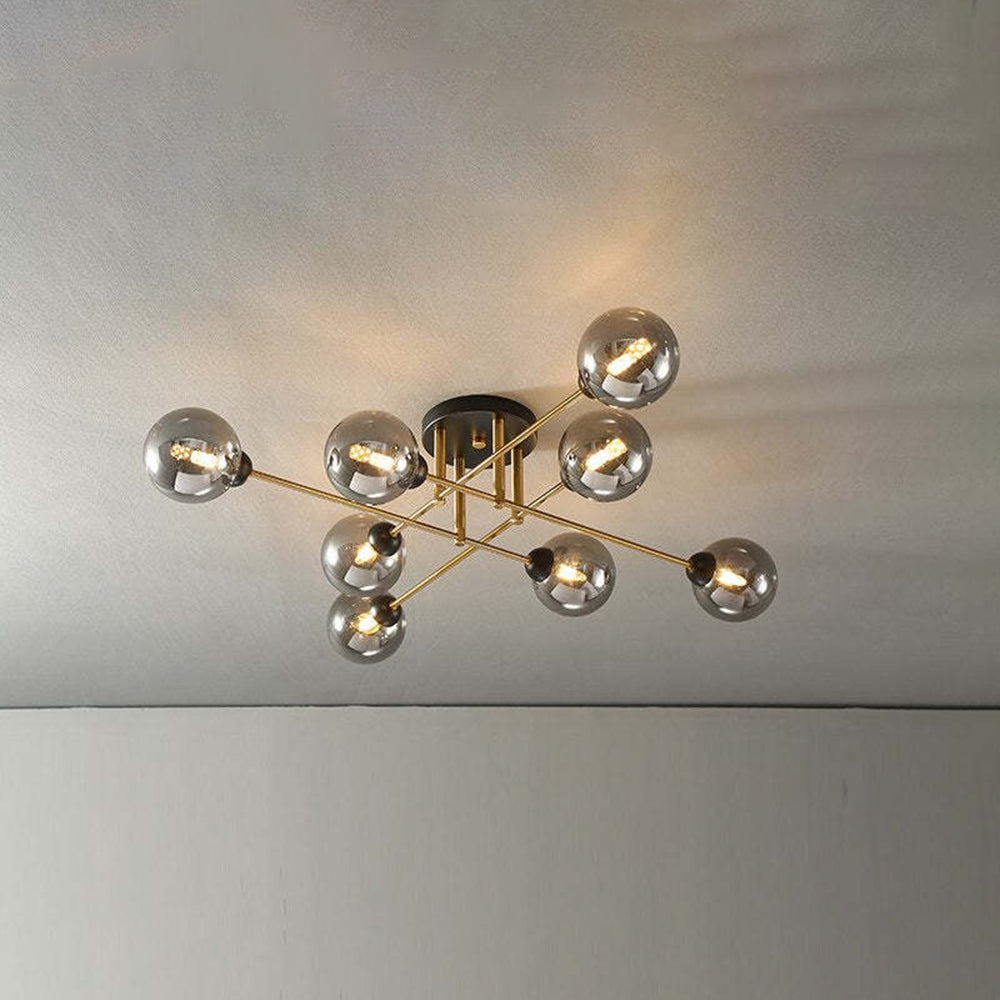 Eight grey smoked globes stay dark and reflective on this Clérachic semi-flush chandelier, gold rods crossing beneath the ceiling.