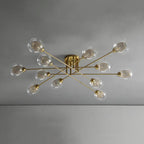 Twelve transparent globes on the all-gold Clérachic sputnik chandelier, each holding a fine gold wire mesh sleeve.