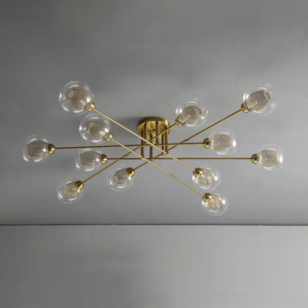Twelve transparent globes on the all-gold Clérachic sputnik chandelier, each holding a fine gold wire mesh sleeve.