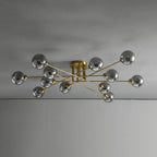 Twelve grey smoked globes on the gold Clérachic sputnik chandelier, its longest rods reaching across a grey ceiling.
