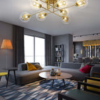 The Clérachic sputnik chandelier seen from the sofa, eight transparent globes lighting an open-plan living and dining room.