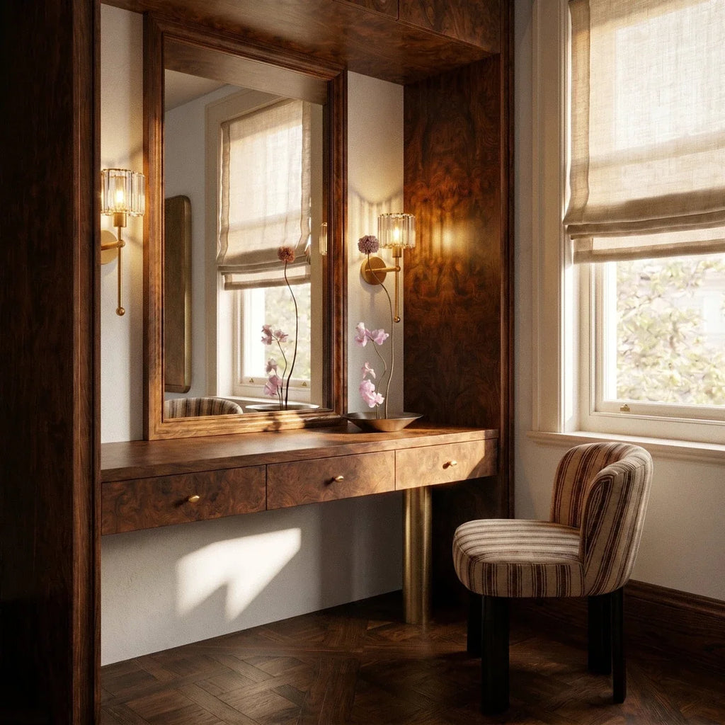 Clérachic pair of gold wall lamps with ribbed glass shades flanking a mirror over a walnut dressing table by a sunlit window.