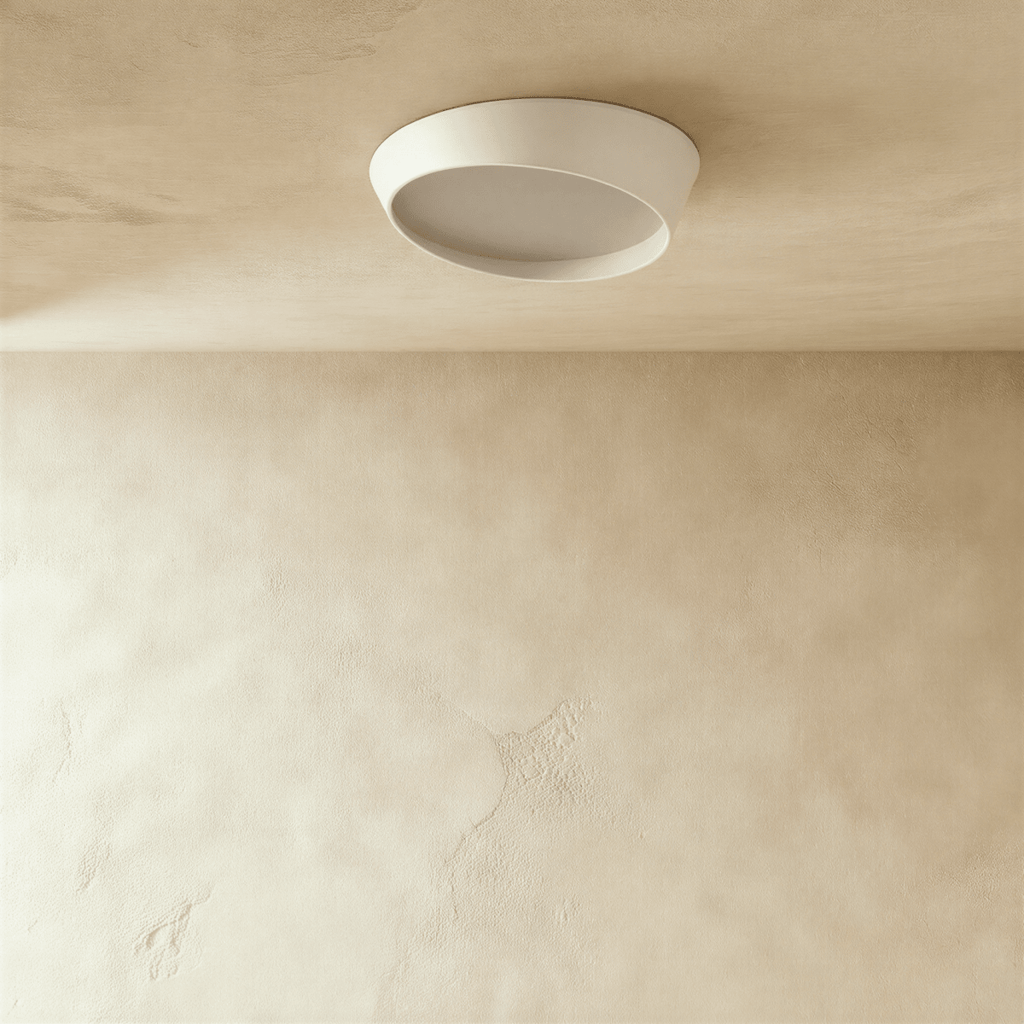 Clérachic round white ceiling light switched off, showing the angled iron rim and the frosted diffuser against a limewash ceiling.