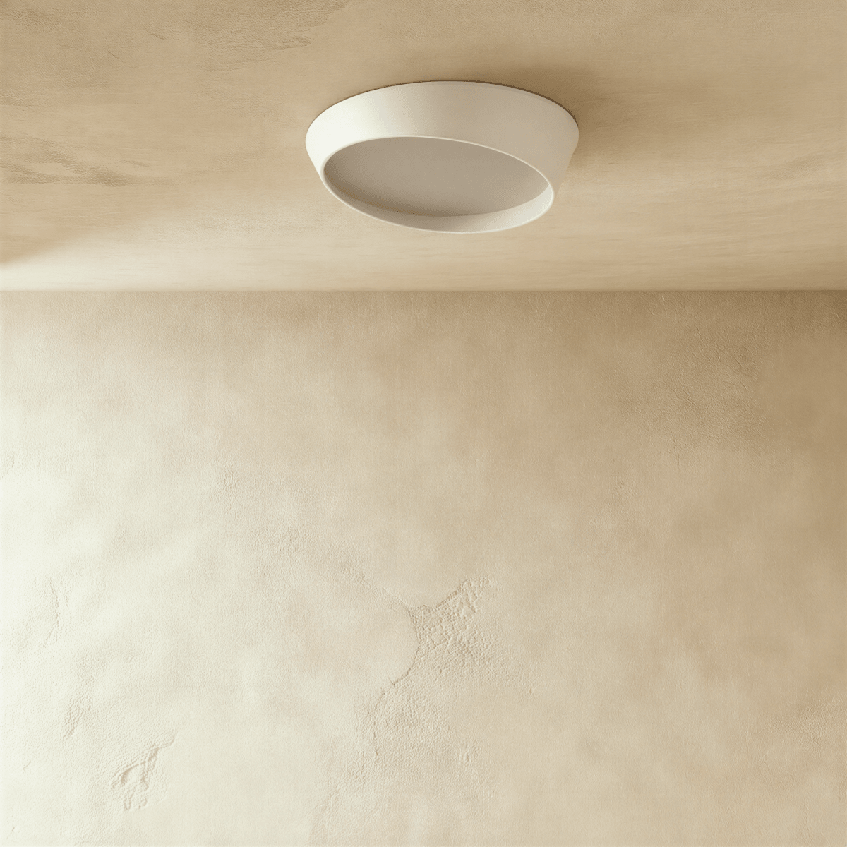 Clérachic round white ceiling light switched off, showing the angled iron rim and the frosted diffuser against a limewash ceiling.