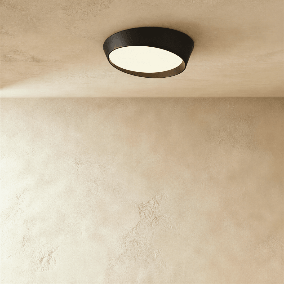 Clérachic round ceiling light with a matte black iron rim and a warm-lit frosted diffuser on a limewash ceiling.