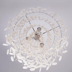 Looking straight up into a chrome-ringed Clérachic shell chandelier, three bulbs visible inside the spiral of white discs.