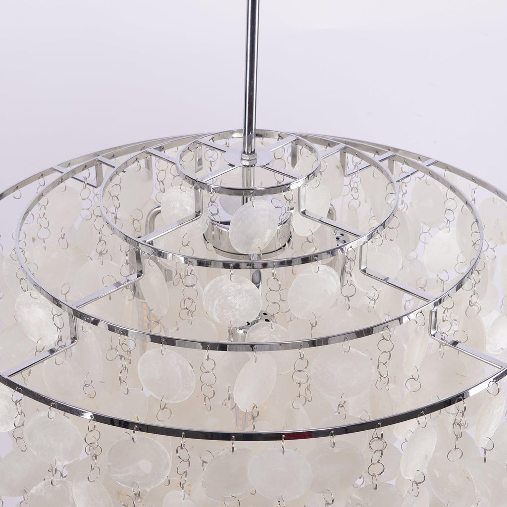 Inside the crown of this Clérachic chandelier, three concentric chrome rings with shell discs hanging on small links.