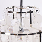 Closer view of a bulb and the chrome arms inside the crown of this Clérachic shell chandelier.