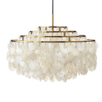 Wide gold-ringed Clérachic shell chandelier on white, with five stepped rings and overlapping white discs below.