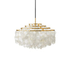 Gold-ringed Clérachic shell chandelier on white, with four stepped rings and a rounded skirt of shell discs.