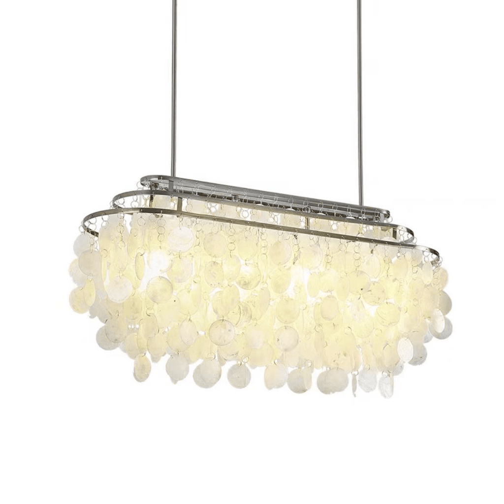Long oval Clérachic shell chandelier with a chrome frame, lit warm, hung on two rods against white.