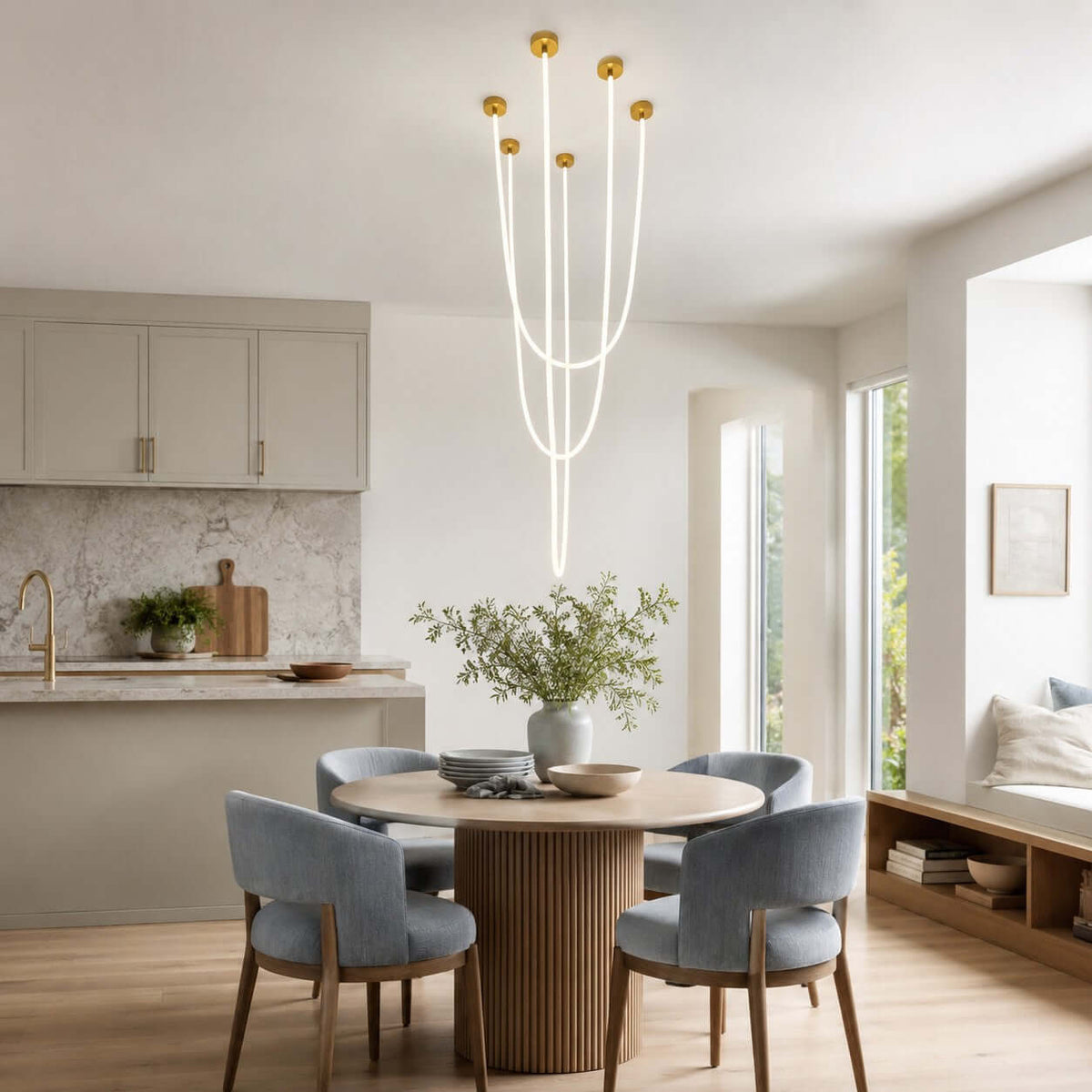 Five lit tubes of this Clérachic pendant light fall in long lines above a round dining table with blue-grey chairs.
