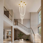 In a tall stairwell with glass balustrades, this Clérachic pendant light lets its glowing tubes fall at several lengths.