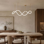 Clérachic wave pendant lit above a rough-stone dining table and walnut chairs, with a large soft painting and a dark wood cabinet.