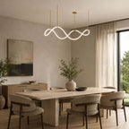 A Clérachic pendant with a bright looping strip hangs in a dining room with an oak table, curved chairs and a dark landscape painting.