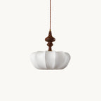 This Clérachic silk pendant with a turned walnut-colour wooden top, shown on a plain white backdrop and hung from a twisted cord.