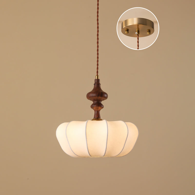 The widest, flattest shade of this Clérachic pendant, with a short turned wooden top and an inset of the brass canopy.