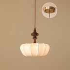 The widest, flattest shade of this Clérachic pendant, with a short turned wooden top and an inset of the brass canopy.