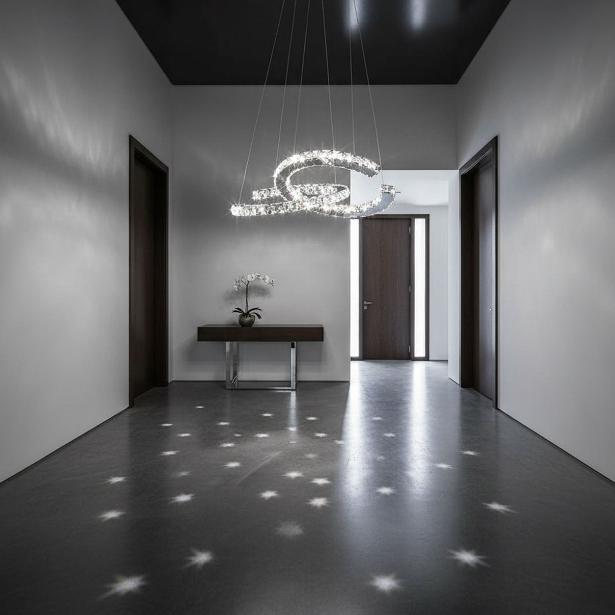 This Clérachic crystal pendant lights a grey hallway, scattering star-shaped points of light over the dark polished floor.