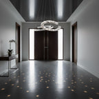 Wide hallway with dark doors and a Clérachic crystal pendant, its light breaking into small stars on the glossy floor.
