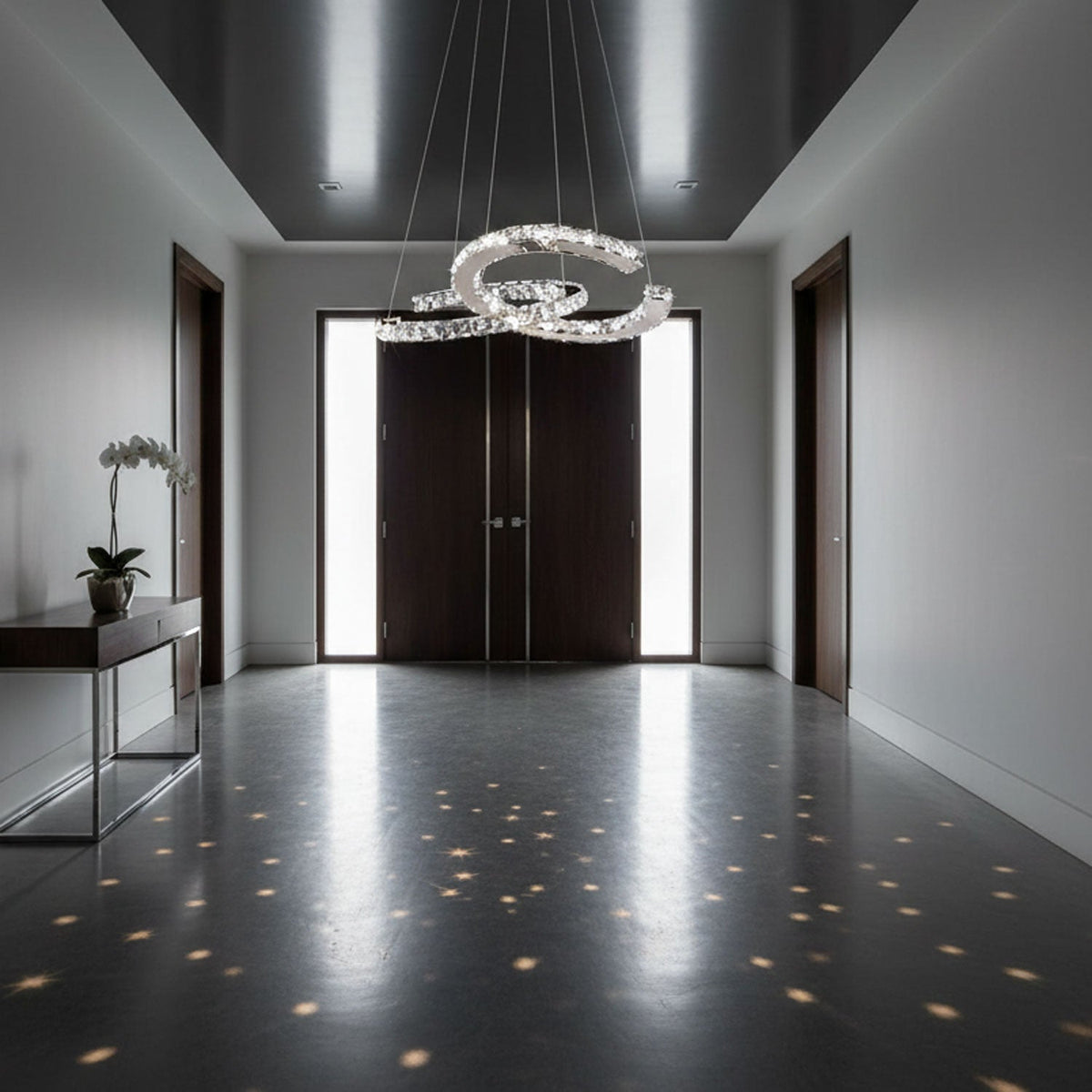 Wide hallway with dark doors and a Clérachic crystal pendant, its light breaking into small stars on the glossy floor.