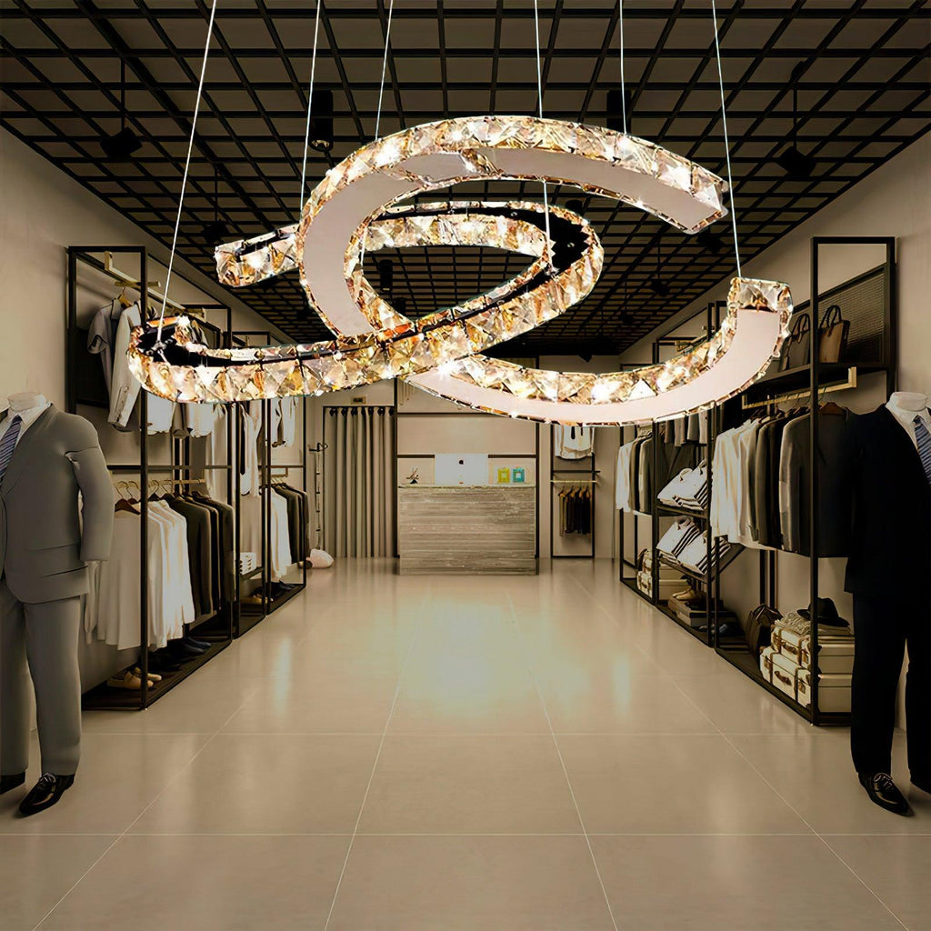 Cognac-toned Clérachic pendant hanging in a clothing boutique, with rails of garments and a tiled floor below.