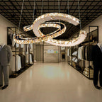 Cognac-toned Clérachic pendant hanging in a clothing boutique, with rails of garments and a tiled floor below.