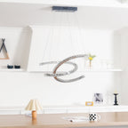 Unlit Clérachic crystal pendant under a dark canopy, with a shelf of glasses and a wooden table behind.