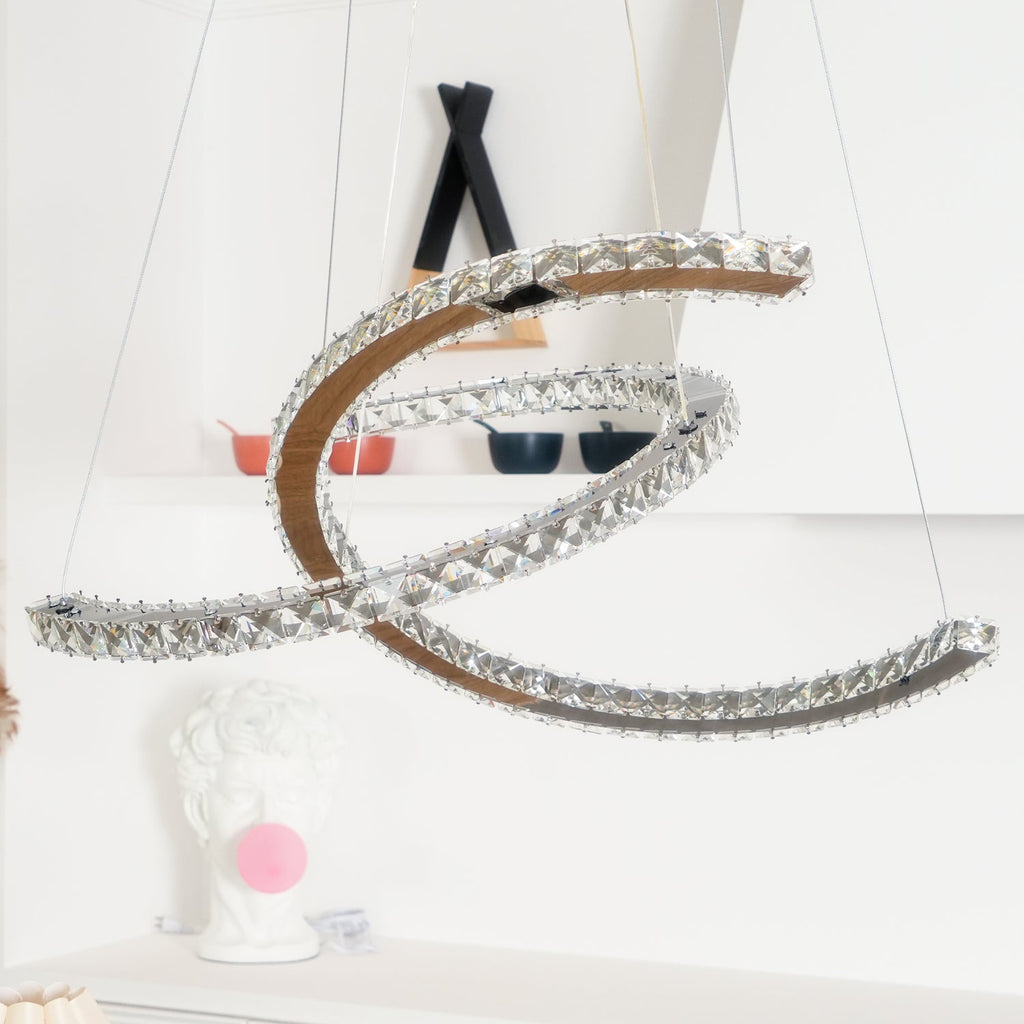 Close view of the unlit Clérachic pendant hung before a white shelf, with a black-and-wood decor piece behind.