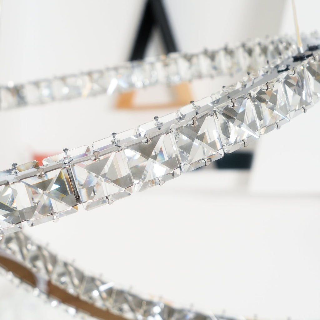 Close view of the square-cut crystals set along one crescent of this Clérachic pendant.