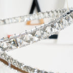 Close view of the square-cut crystals set along one crescent of this Clérachic pendant.